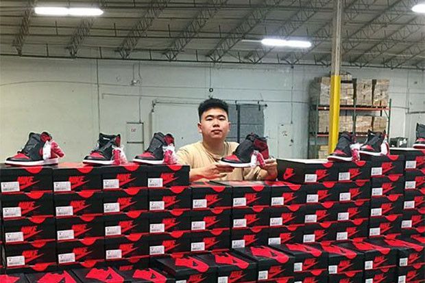 Sneaker reseller Allen Kuo posing with newly released Jordans