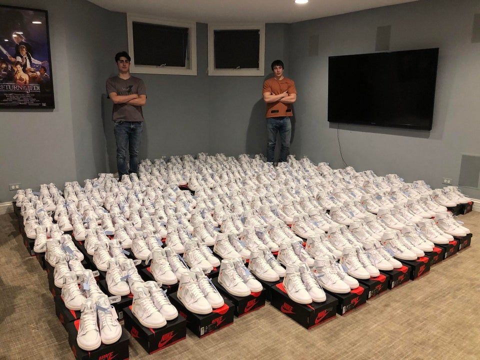 Sneaker resellers posing with a large quantity of Off-White Jordans